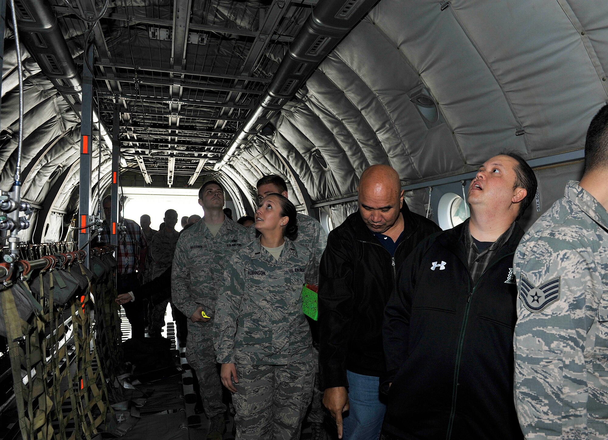 Members from the 733rd Air Mobility Squadron observe the inside of a Japan Air Self Defense Force C-1 cargo jet during a tour, March 10, 2016, at Naha Air Base, Japan. The tour program enabled U.S. Air Force and JASDF members to exchange ideas for improving coalition partnerships and operational capability. (U.S. Air Force photo by Naoto Anazawa)

