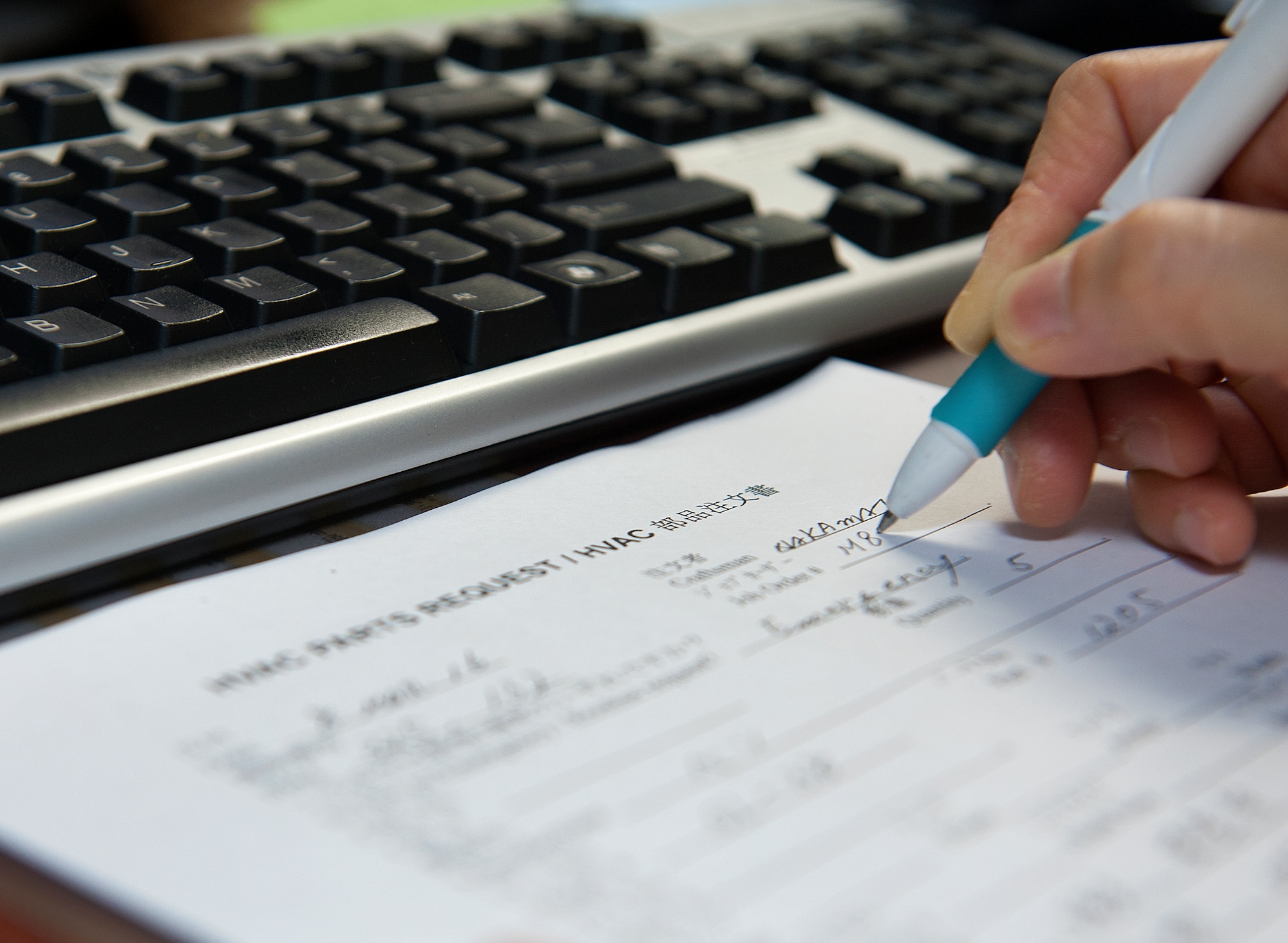 Ayano Kinjo, 18th Civil Engineer Squadron facilities repair estimator, fills out an HVAC parts request form, March 9, 2016, at Kadena Air Base, Japan. Kinjo assists the 18th CES's Operations Flight with maintaining 23.4 million square feet of facilities, 17 dormitories, all fire and security alarms, jet fuel storage tanks and 61,000 linear feet of piping, 13.5 miles of aircraft fuel lines, 107 generators supporting critical facilities, 1,000 miles of potable water and sewer lines including 1,500 fire hydrants and 43 sewage lift stations, 780 miles of overhead and underground electrical distribution lines, 570 miles of storm drains island wide and 564 million square feet of airfield pavement. (U.S. Air Force photo by Naoto Anazawa)


