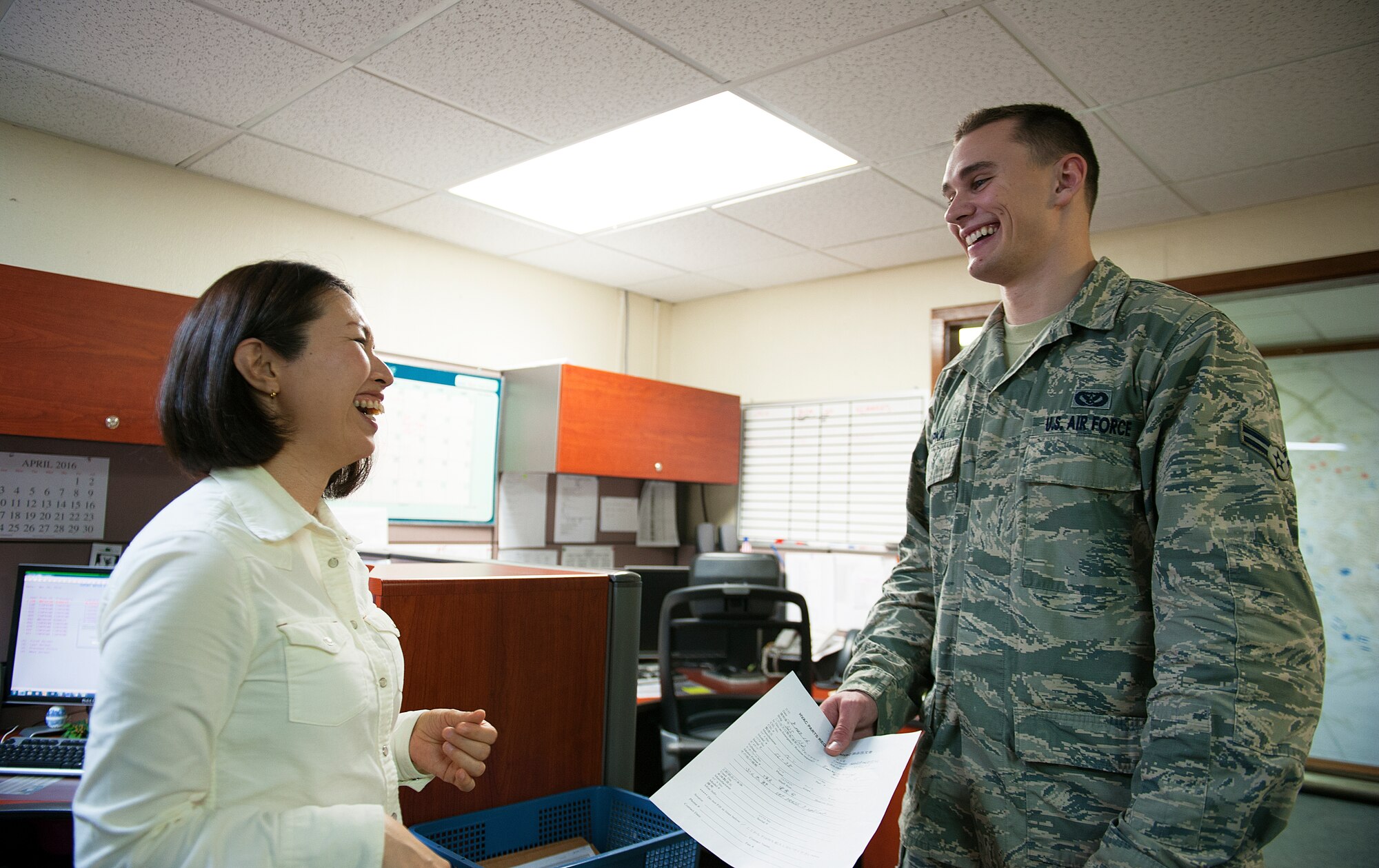 U.S. Air Force Airman 1st Class Barak Lapka, 18th Civil Engineer Squadron heating, ventilation, air conditioning and refrigeration journeyman, shows an HVAC parts request form to Ayano Kinjo, 18th CES facilities repair estimator to review, March 9, 2016, at Kadena Air Base, Japan. According to Kinjo, the members of the 18th CES warmly welcomed her since the start of her job. (U.S. Air Force photo by Naoto Anazawa)



