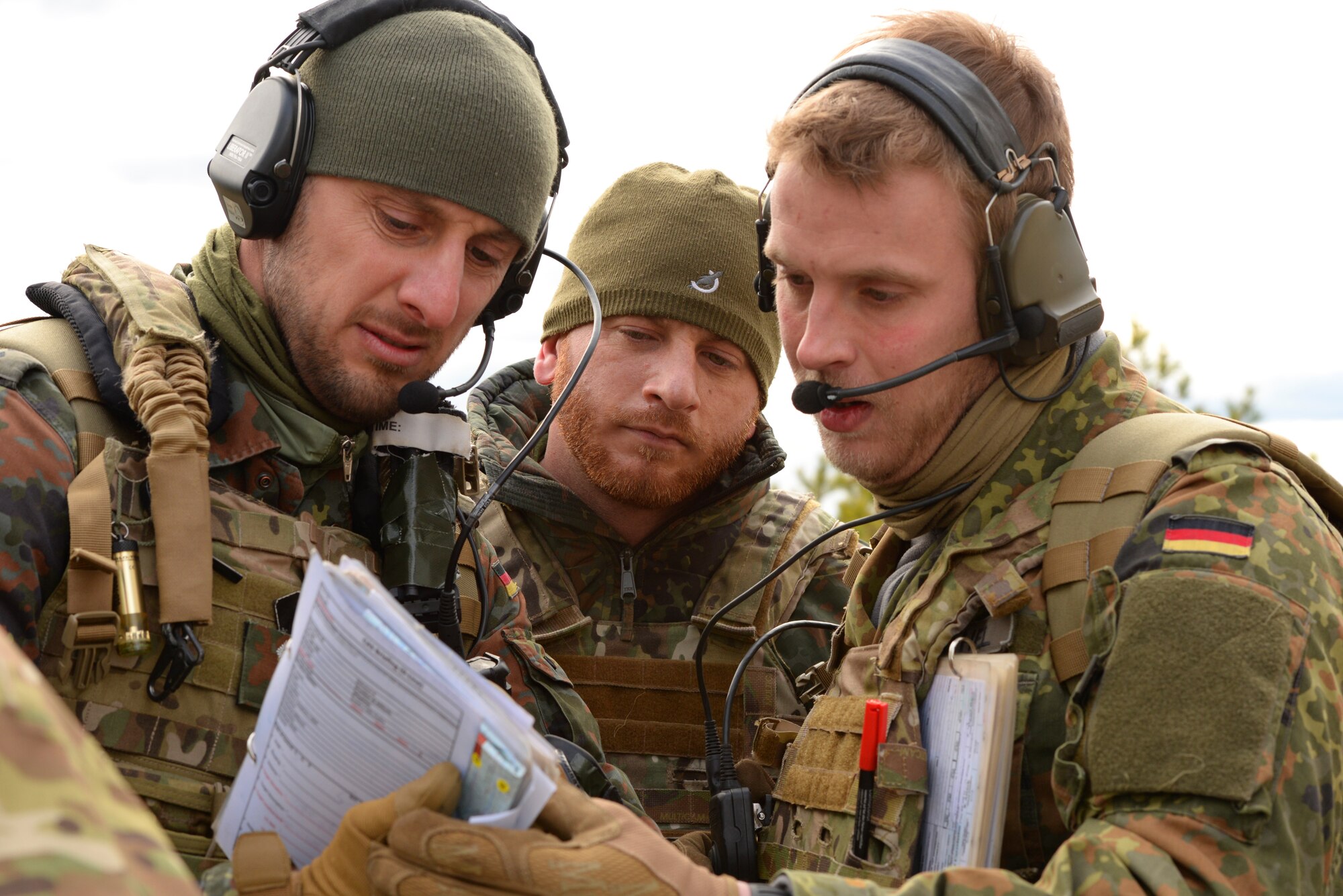A picture of German armed forces Joint Terminal Attack Controllers (JTACs) 1st Lt. Marius Sokol, Capt. Sebastian Pflueger and 2d Lt. Michael Barthel, performing close air support training.