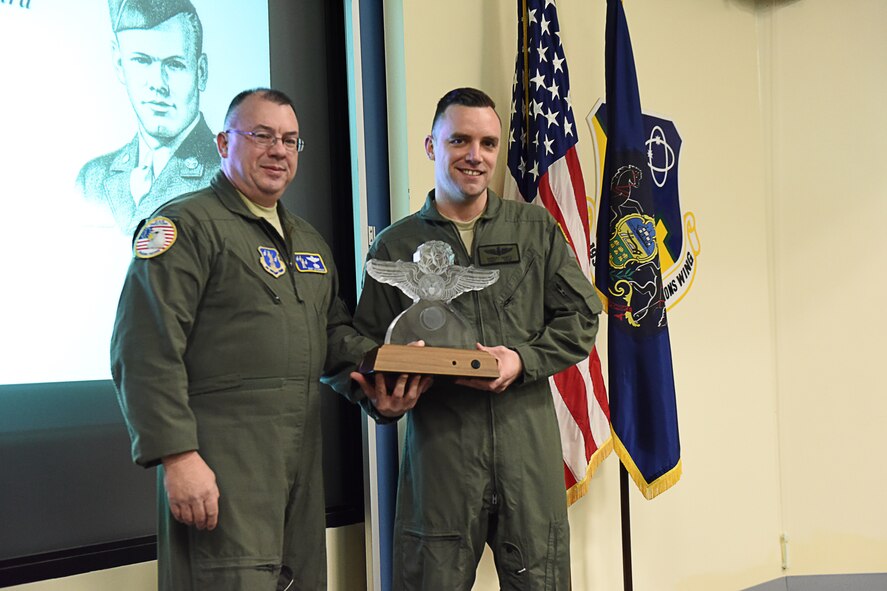 Tech. Sgt. Robert W. Gantz (right), an EC-130J loadmaster with the 193rd Special Operations Wing, Middletown, Pennsylvania, receives the Red Erwin Award March 12. He was presented this award for his outstanding performance and leadership that impacted the unit's mission in support of the enlisted aircrew operations career field. (U.S. Air National Guard photo by Senior Airman Ethan Carl/Released)