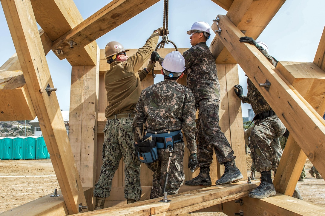 Seabees from the U.S. Navy and the Republic of Korea raise a timber tower during exercise Foal Eagle 2016 in Busan, South Korea, March 3, 2016. Foal Eagle is an annual bilateral training exercise designed to enhance interoperability during a crisis. The U.S. Seabees are from Naval Mobile Construction Battalion 133. Navy photo by Petty Officer Lowell Whitman

