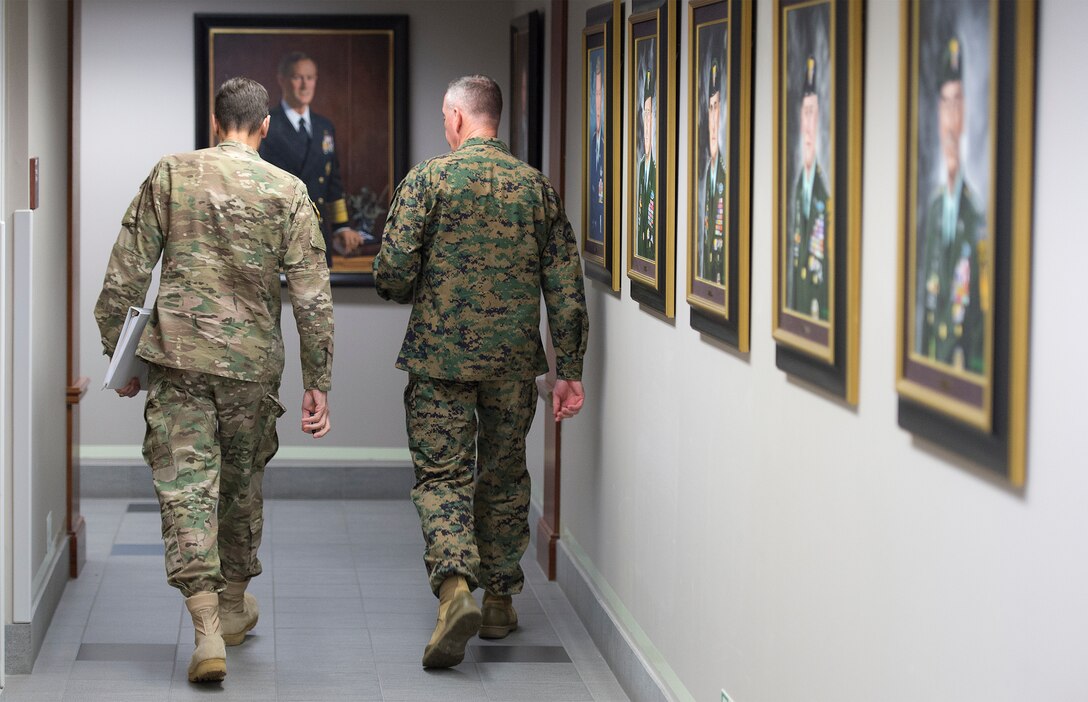 Marine Corps Gen. Joseph F. Dunford Jr., chairman of the Joint Chiefs of Staff, right, and Army Gen. Joseph L. Votel, commander of U.S. Special Operations Command, walk down the "commander's corridor" at Socom headquarters on MacDill Air Force Base, Fla., March 11, 2016. DoD photo by Navy Petty Officer 2nd Class Dominique A. Pineiro