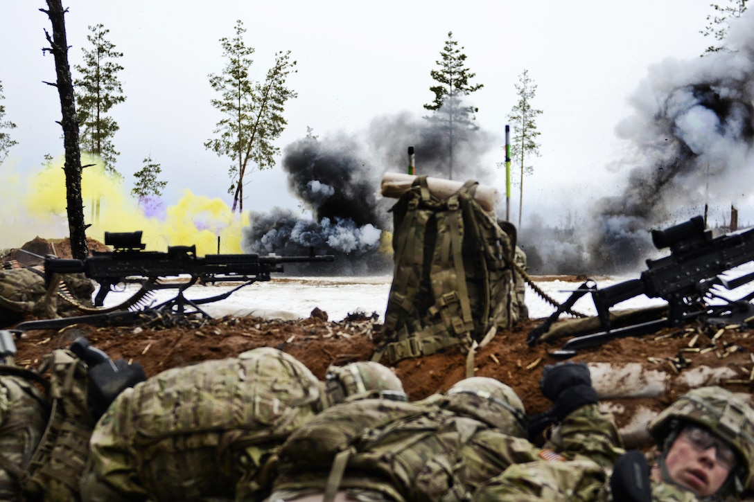 Soldiers find cover behind a berm as an explosion breaches the entrance of the enemy battle area during a live-fire exercise at Tapa Training Area in Estonia, March 12, 2016. Army photo by Staff Sgt. Steven M. Colvin