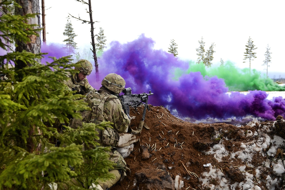 Soldiers set up their positions behind a berm to fire at enemy targets under the concealment of colored smoke during a live-fire exercise at Tapa Training Area in Estonia, March 12, 2016. Army photo by Staff Sgt. Steven M. Colvin