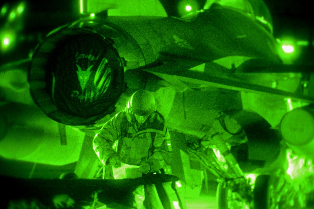 As seen through a night-vision device, an airman conducts night flight line operations on an F-16 Fighting Falcon during Exercise Dastardly Devil 16-1 at the Atlantic City Air National Guard Base, N.J., March 12, 2016. The airmen are assigned to the 177th Fighter Wing's Maintenance Squadron. New Jersey Air National Guard photo by Tech. Sgt. Andrew Merlock