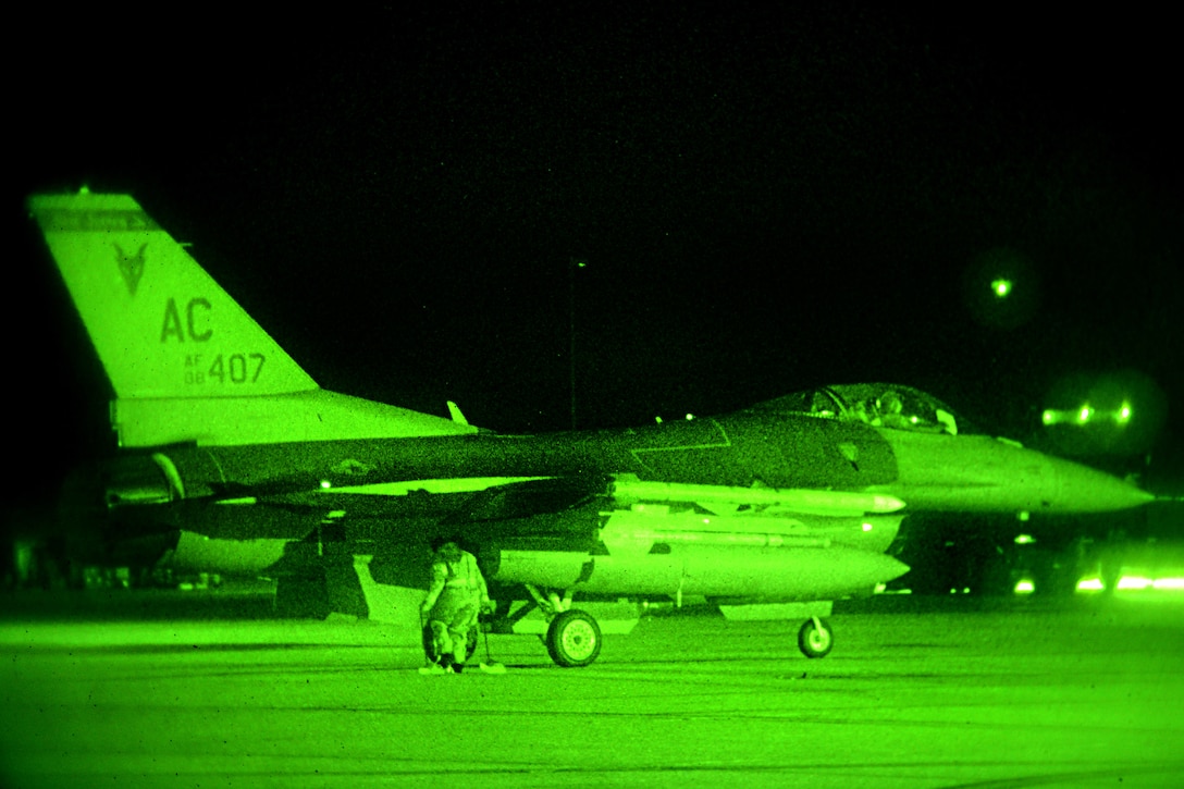 As seen through a night-vision device, airmen conduct night flight line operations on an F-16 Fighting Falcon during Exercise Dastardly Devil 16-1 at the Atlantic City Air National Guard Base, N.J., March 12, 2016. New Jersey Air National Guard photo by Tech. Sgt. Andrew Merlock