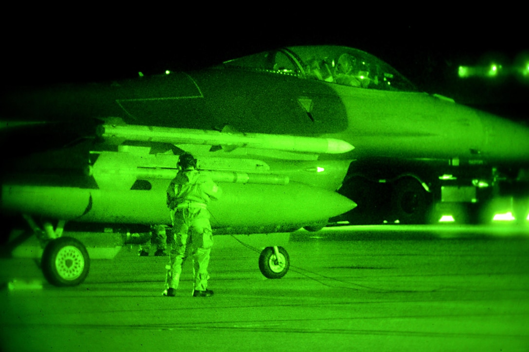 As seen through a night-vision device, an airman performs final preflight checks on an F-16 Fighting Falcon aircraft during Exercise Dastardly Devil 16-1 at the Atlantic City Air National Guard Base, N.J., March 12, 2016. New Jersey Air National Guard photo by Tech. Sgt. Andrew Merlock