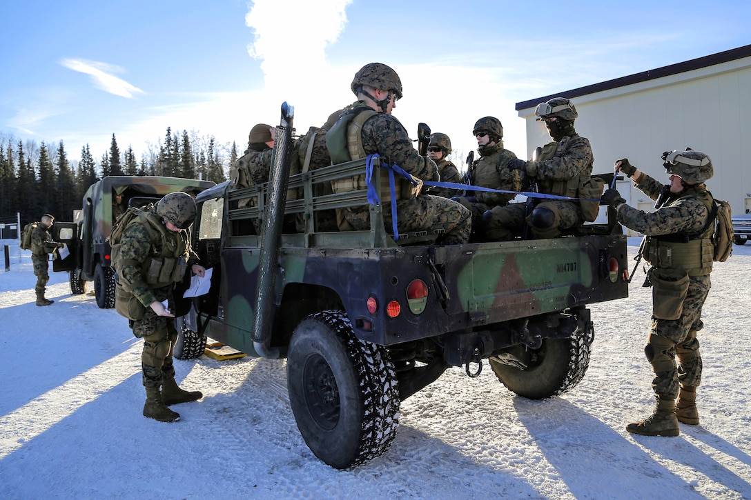 Marines prepare to convoy to Baumeister City military operations at the urban terrain complex on Joint Base Elmendorf-Richardson, Alaska, March 6, 2016. Air Force photo by Alejandro Pena