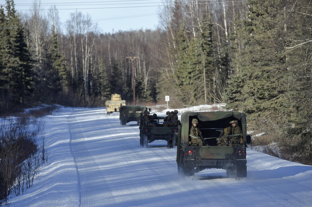 A Humvee convoy transporting Marines proceeds to Baumeister City en route to urban terrain training on Joint Base Elmendorf-Richardson, Alaska, March 6, 2016. Air Force photo by Alejandro Pena