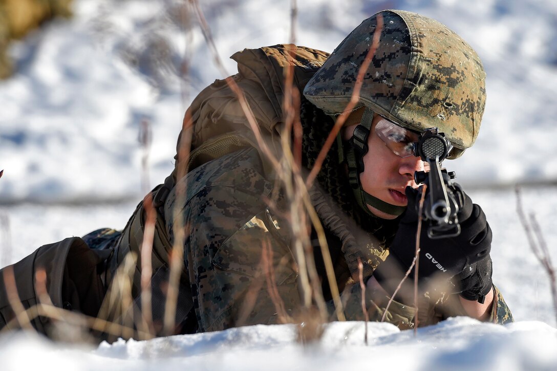 Marine Corps Cpl. Deion Delara provides security in his sector during a convoy security halt on Joint Base Elmendorf-Richardson, Alaska, March 6, 2016. Delara is assigned to Detachment Military Police Delta Company, 4th Law Enforcement Battalion. Air Force photo by Alejandro Pena