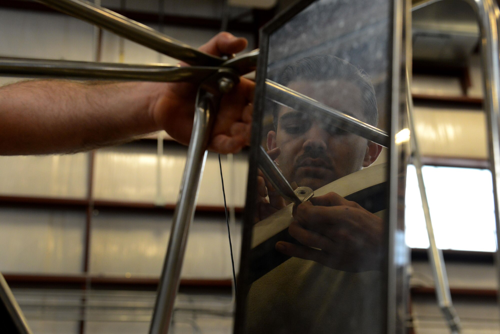 U.S. Air Force Senior Airman Ryan Marney, 20th Logistics Readiness Squadron vehicle maintenance flight vehicle maintenance journeyman, fixes a broken mirror on a truck at Shaw Air Force Base, S.C., March 8, 2016. The 20th LRS VMF has more than 40 maintainers who are responsible for the upkeep of more than 400 vehicles. (U.S. Air Force photo by Airman 1st Class Destinee Dougherty)