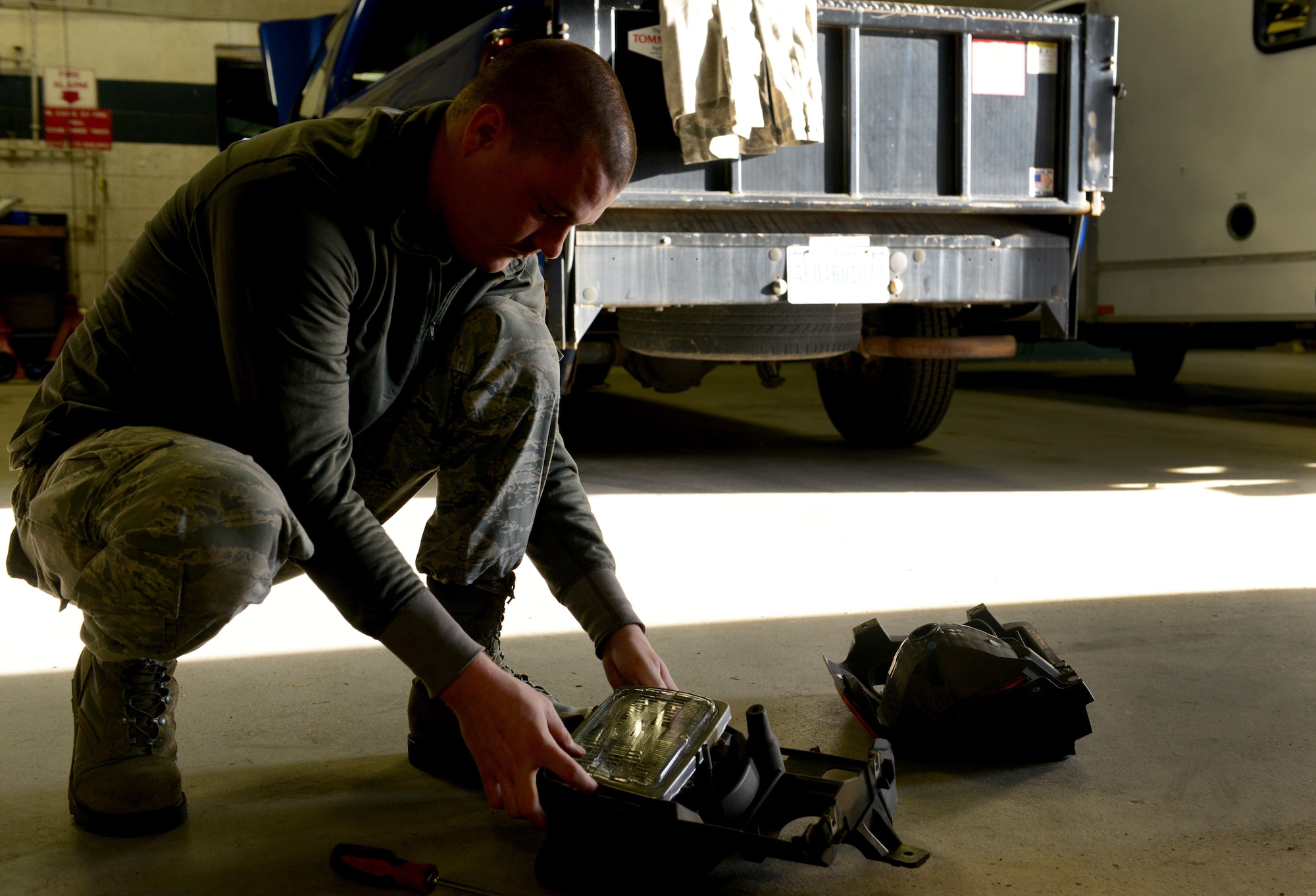 U.S. Air Force Staff Sgt. Trent Tillman, 20th Logistics Readiness Squadron vehicle maintenance flight material handling equipment maintainer, assembles a headlight for a government-owned vehicle at Shaw Air Force Base, S.C., March 8, 2016. The 20th LRS VMF is in charge of maintaining over 400 vehicles at Shaw. (U.S. Air Force photo by Airman 1st Class Destinee Dougherty)