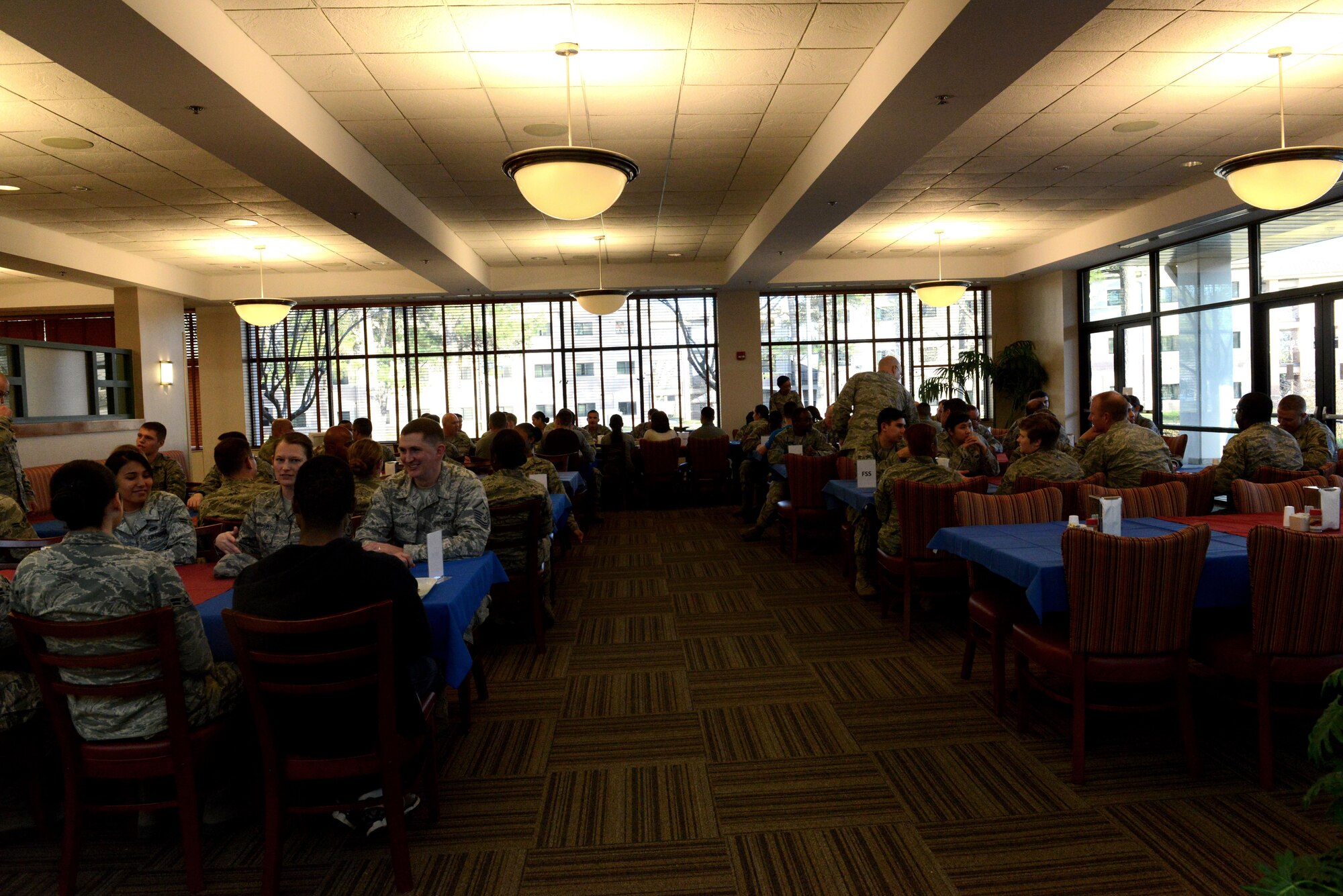 U.S. Airmen eat dinner at the Chief Master Sgt. Emerson E. Williams Dining Facility at Shaw Air Force Base, S.C., March 9, 2016. The “Reboot your Resolution” Airman/Soldier Appreciation Dinner invited Airmen and Soldiers from all ranks to share a meal together. (U.S. Air Force photo by Airman 1st Class Destinee Dougherty)