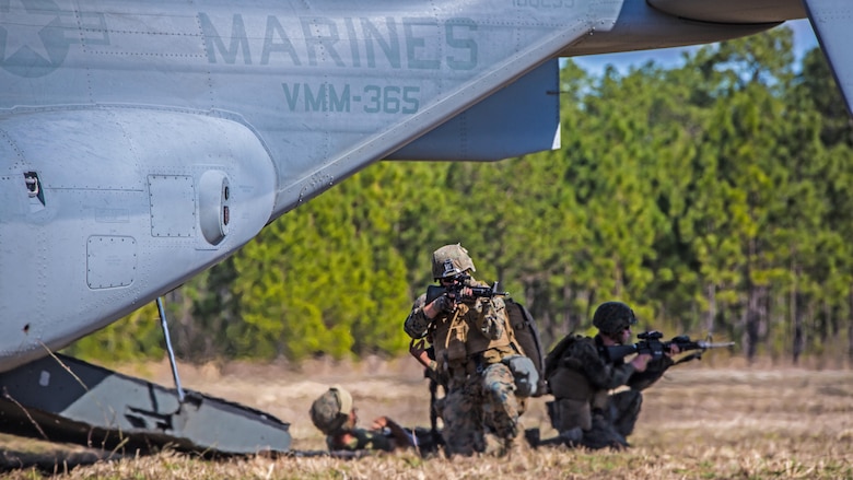 Marines with 2nd Combat Engineer Battalion, provide security before loading a casualty into a MV-22 Osprey during a casualty evacuation exercise at Landing Zone Penguin at Marine Corps Base Camp Lejeune, N.C., March 10, 2016. The training allowed Marines with Marine Medium Tiltrotor Squadron 365 and 2nd CEB to work together in order to be well prepared to conduct a successful CASEVAC in any situation they may encounter while deployed, to ultimately save lives.