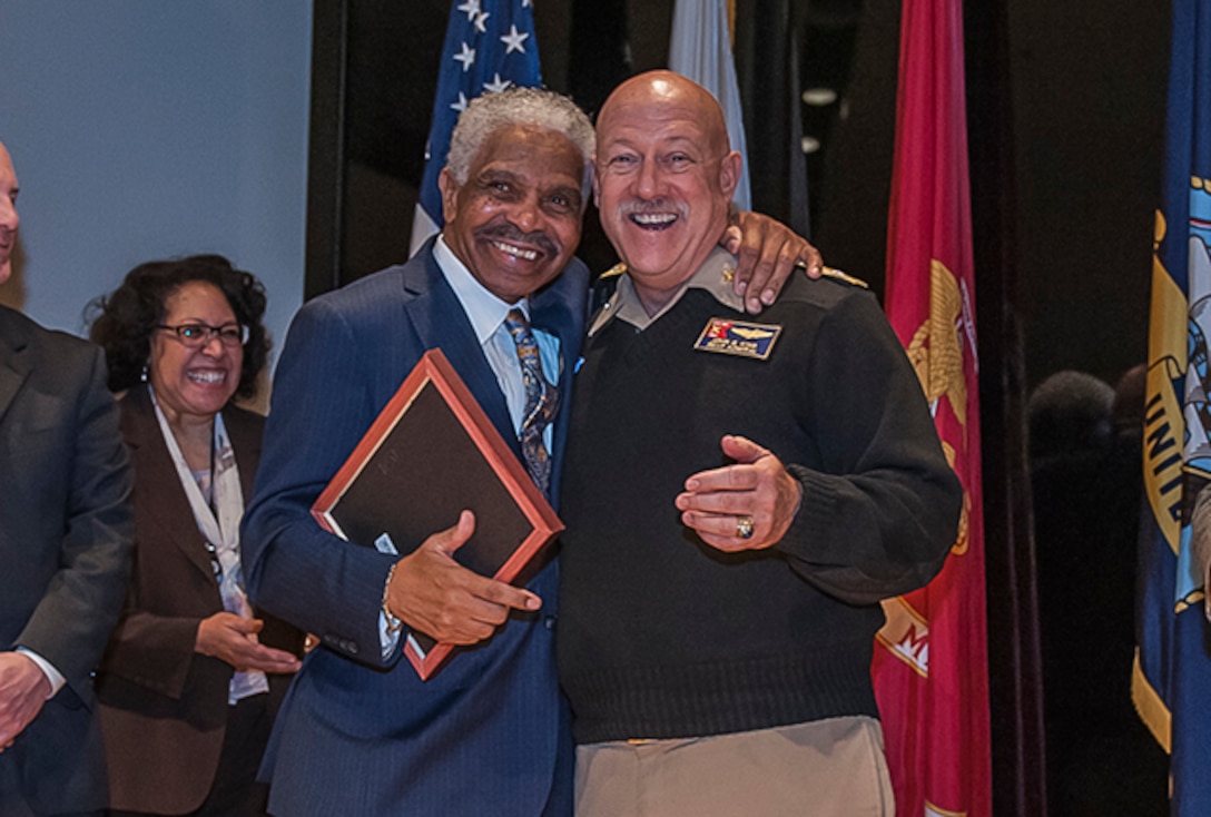 Charles Tennant, Sr joined Navy Rear Adm. John King for a commemorative gift presentation after his insightful history lesson.