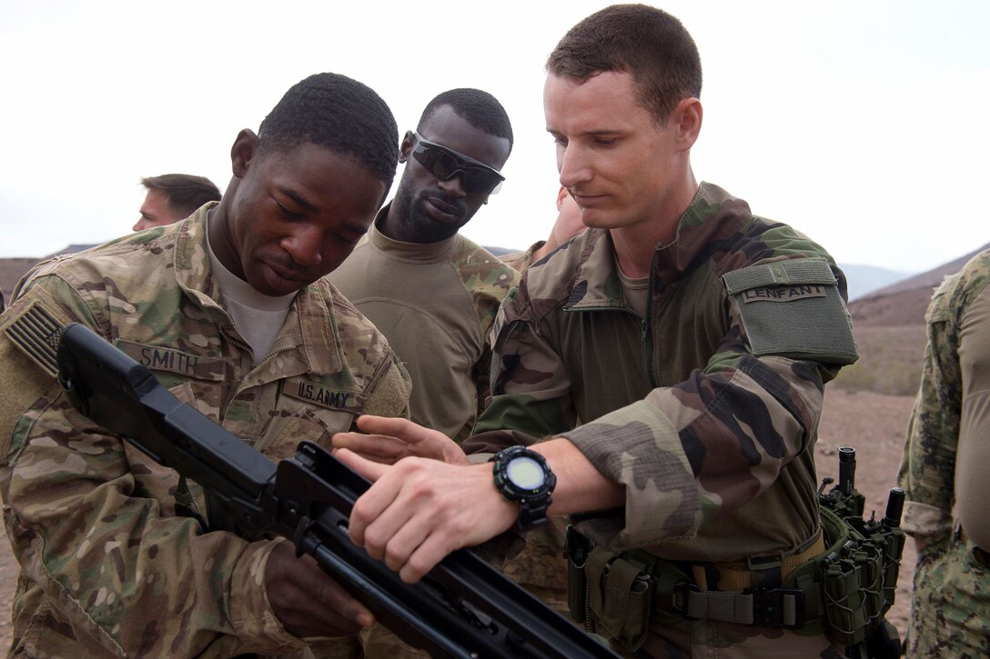 A French Foreign Legion soldier, right, teaches rifle operations to U.S. soldiers during small arms training at a firing range in Djibouti, March 5, 2016. Air Force photo by Tech. Sgt. Barry Loo
