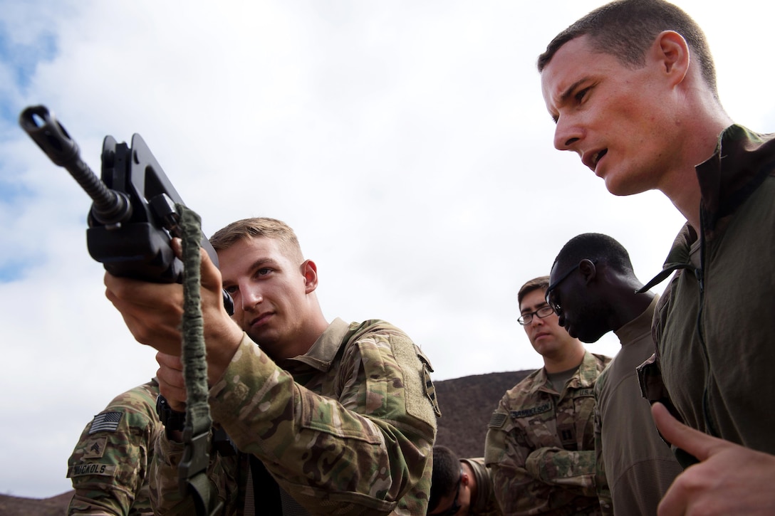 A French Foreign Legion soldier, right, teaches rifle operations to U.S. soldiers during small arms training at a firing range in Djibouti, March 5, 2016. Air Force photo by Tech. Sgt. Barry Loo