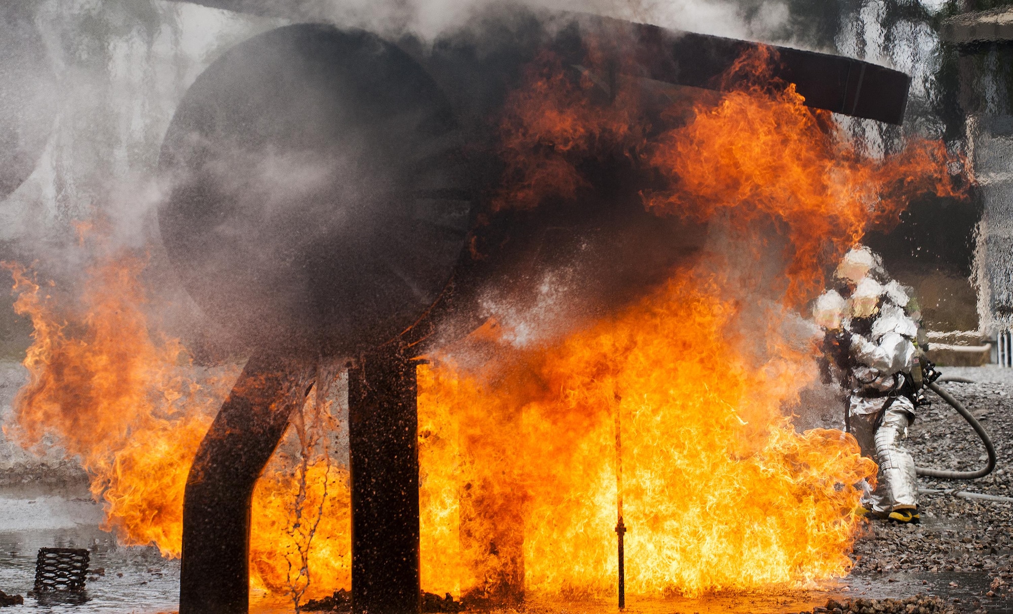 A team of 919th Special Operations Civil Engineer Squadron firefighters move in to battle an engine fire during a live-fire training exercise March 4 at Hurlburt Field, Fla.  The Reserve Airmen teamed with their active-duty special operations firefighters to complete their annual live-fire training during the March unit training assembly.  (U.S. Air Force photo/Tech. Sgt. Sam King)