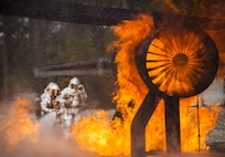 A team of 919th Special Operations Civil Engineer Squadron firefighters move in to battle an engine fire during a live-fire training exercise March 4 at Hurlburt Field, Fla.  The Reserve Airmen teamed with their active-duty special operations firefighters to complete their annual live-fire training during the March unit training assembly.  (U.S. Air Force photo/Tech. Sgt. Sam King)
