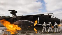 A team of 919th Special Operations Civil Engineer Squadron firefighters move in to battle an engine fire during a live-fire training exercise March 4 at Hurlburt Field, Fla.  The Reserve Airmen teamed with their active-duty special operations firefighters to complete their annual live-fire training during the March unit training assembly.  (U.S. Air Force photo/Tech. Sgt. Sam King)
