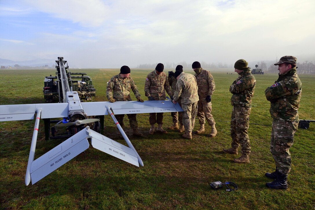 U.S. Army paratroopers show Slovenian soldiers how to conduct pre-flight checks on an RQ7B Shadow unmanned aircraft system during Exercise Rock Sokol at Aeroclub Postonja in Slovenia, March 2, 2016. The paratroopers are assigned to the 54th Brigade Engineer Battalion, 173rd Airborne Brigade. Exercise Rock Sokol is a bilateral training exercise between the U.S. Army 173rd Airborne Brigade and Slovenian armed forces focused on small-unit tactics and building on previous lessons learned, forging bonds and enhancing readiness between allied forces. Army photo by Paolo Bovo