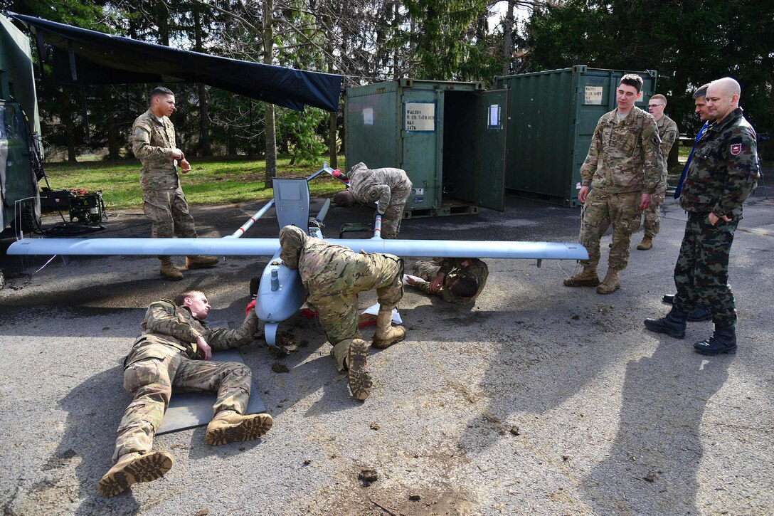 U.S. Army paratroopers wipe down an RQ7B Shadow unmanned aircraft system during post-flight checks as part of Exercise Rock Sokol at Aeroclub Postonja in Slovenia, March 2, 2016. Army photo by Paolo Bovo