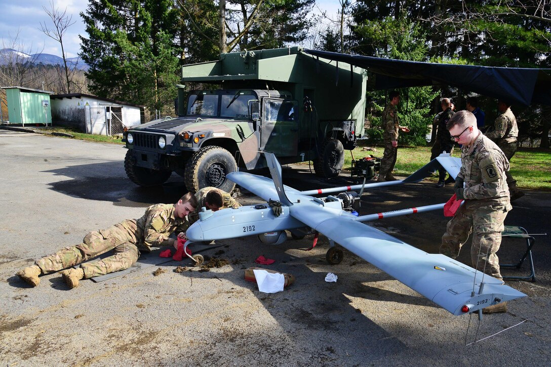 U.S. Army paratroopers perform maintenance and wipe down an RQ7B Shadow unmanned aircraft system during post-flight checks as part of Exercise Rock Sokol at Aeroclub Postonja in Slovenia, March 2, 2016. Army photo by Paolo Bovo