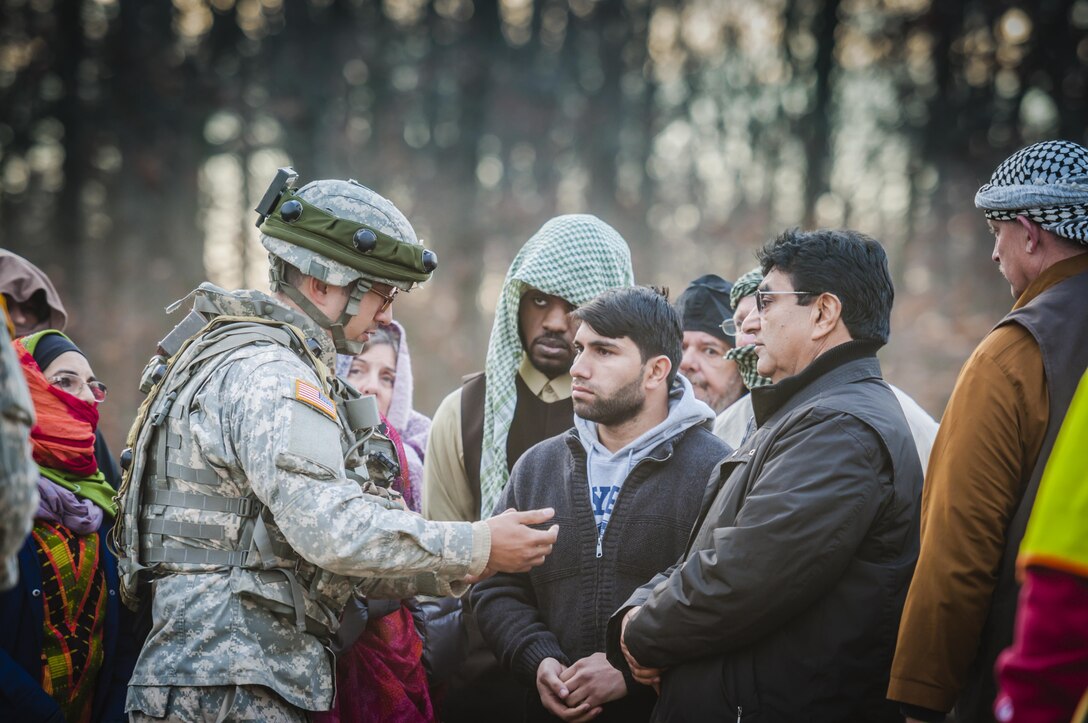 1st Lt. Charles W. Breeden, commander of the 309th Transportation Detachment, speaks with a civilian roleplayer acting as a tribal leader during Combat Support Training Exercise 2016 at Joint Base McGuire-Dix-Lakehurst, N.J. March 8, 2016. CSTX is a U.S. Army Reserve exercise conducted at multiple locations across the country designed to challenge combat support units and Soldiers to improve and sustain skills necessary during a deployment. (U.S. Army photo by Sgt. Michael T. Crawford/RELEASED)