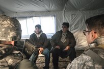 Staff Sgt. Jason Leabo (left), non-commissioned officer in charge of the 309th Transportation Detachment, and 1st Lt. Charles W. Breeden, commander of the 309th Trans. Det., negotiate needs and wants with civilian roleplayers acting as tribal representatives during Combat Support Training Exercise 2016 at Joint Base McGuire-Dix-Lakehurst, N.J. March 8, 2016. CSTX is a U.S. Army Reserve exercise conducted at multiple locations across the country designed to challenge combat support units and Soldiers to improve and sustain skills necessary during a deployment. (U.S. Army photo by Sgt. Michael T. Crawford/RELEASED)
