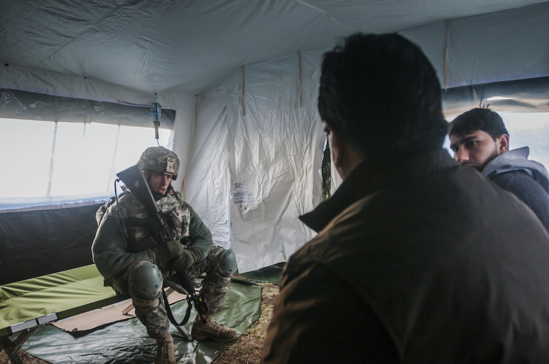 Staff Sgt. Jason Leabo, non-commissioned officer in charge of the 309th Transportation Detachment based in Panama Cita, Fla., negotiates needs and wants with civilian roleplayers acting as tribal representatives during Combat Support Training Exercise 2016 at Joint Base McGuire-Dix-Lakehurst, N.J. March 8, 2016. CSTX is a U.S. Army Reserve exercise conducted at multiple locations across the country designed to challenge combat support units and Soldiers to improve and sustain skills necessary during a deployment. (U.S. Army photo by Sgt. Michael T. Crawford/RELEASED)
