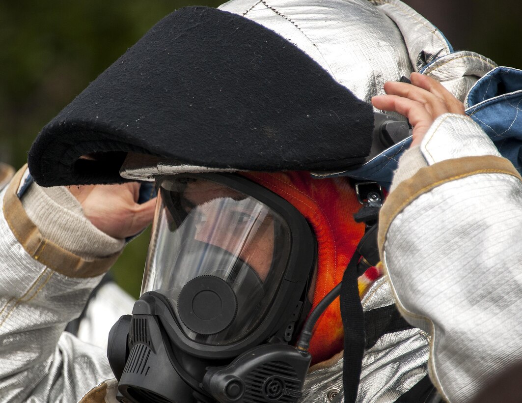 A 919th Special Operations Civil Engineer Squadron Airman secures his helmet prior to a live-fire training exercise March 4 at Hurlburt Field, Fla.  The Reserve Airmen teamed with their active-duty special operations firefighters to complete their annual live-fire training during the March unit training assembly.  (U.S. Air Force photo/Tech. Sgt. Sam King)