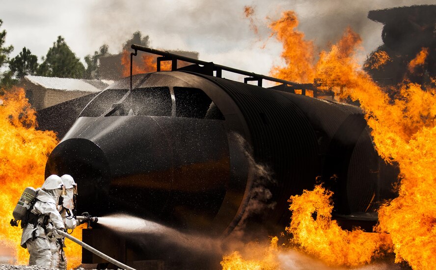 A team of 919th Special Operations Civil Engineer Squadron firefighters battle a huge blaze during a live-fire training exercise March 4 at Hurlburt Field, Fla.  The Reserve Airmen teamed with their active-duty special operations firefighters to complete their annual live-fire training during the March unit training assembly.  (U.S. Air Force photo/Tech. Sgt. Sam King)
