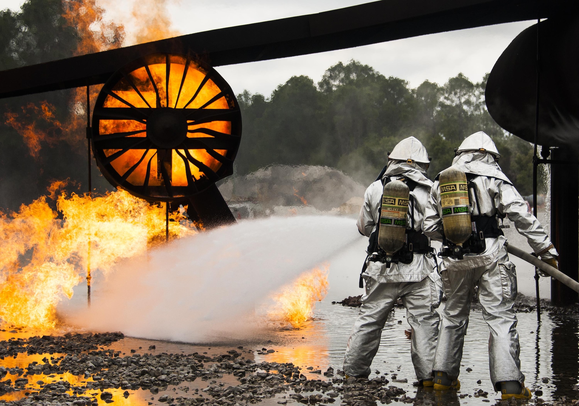 A team of 919th Special Operations Civil Engineer Squadron firefighters move in to battle an engine fire during a live-fire training exercise March 4 at Hurlburt Field, Fla.  The Reserve Airmen teamed with their active-duty special operations firefighters to complete their annual live-fire training during the March unit training assembly.  (U.S. Air Force photo/Tech. Sgt. Sam King)