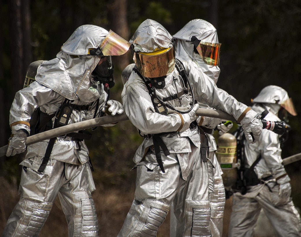 A team of 919th Special Operations Civil Engineer Squadron firefighters strategize their plan before the next round of live-fire training March 4 at Hurlburt Field, Fla.  The Reserve Airmen teamed with their active-duty special operations firefighters to complete their annual live-fire training during the March unit training assembly.  (U.S. Air Force photo/Tech. Sgt. Sam King)