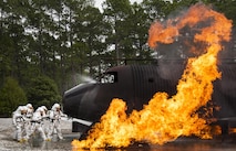 A team of 919th Special Operations Civil Engineer Squadron firefighters battle a huge blaze during a live-fire training exercise March 4 at Hurlburt Field, Fla.  The Reserve Airmen teamed with their active-duty special operations firefighters to complete their annual live-fire training during the March unit training assembly.  (U.S. Air Force photo/Tech. Sgt. Sam King)