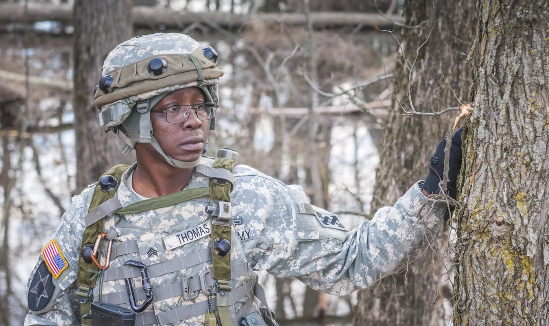 Sgt. Dwayne Thomas, a motor transport operator with the 525th Transportation Detachment based in Statham, Ga., observes a group of approaching protestors during Combat Support Training Exercise 78-16-01 at Joint Base McGuire-Dix-Lakehurst, N.J., March 8, 2016. CSTX 78-16-01 is a U.S. Army Reserve exercise conducted at multiple locations across the country designed to challenge combat support units and Soldiers to improve and sustain skills necessary during a deployment. (U.S. Army photo by Spc. Gregory Lydick/Released)