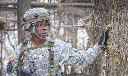 Sgt. Dwayne Thomas, a motor transport operator with the 525th Transportation Detachment based in Statham, Ga., observes a group of approaching protestors during Combat Support Training Exercise 78-16-01 at Joint Base McGuire-Dix-Lakehurst, N.J., March 8, 2016. CSTX 78-16-01 is a U.S. Army Reserve exercise conducted at multiple locations across the country designed to challenge combat support units and Soldiers to improve and sustain skills necessary during a deployment. (U.S. Army photo by Spc. Gregory Lydick/Released)