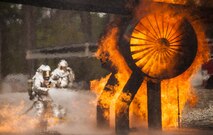 A team of 919th Special Operations Civil Engineer Squadron firefighters move in to battle an engine fire during a live-fire training exercise March 4 at Hurlburt Field, Fla.  The Reserve Airmen teamed with their active-duty special operations firefighters to complete their annual live-fire training during the March unit training assembly.  (U.S. Air Force photo/Tech. Sgt. Sam King)