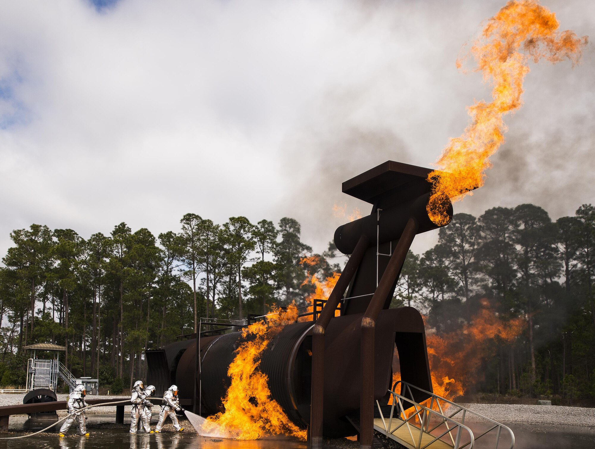 A team of 919th Special Operations Civil Engineer Squadron firefighters battle a huge blaze during a live-fire training exercise March 4 at Hurlburt Field, Fla.  The Reserve Airmen teamed with their active-duty special operations firefighters to complete their annual live-fire training during the March unit training assembly.  (U.S. Air Force photo/Tech. Sgt. Sam King)