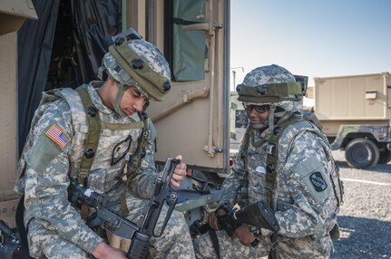 Pfc. Michael Smith teaches Pfc. Destinee Lanier, both multi-channel transmission systems operator-maintainers with the 324th Expeditionary Signal Battalion in Fort Gordon, Ga., how to properly inspect an M16 rifle in a field environment during Combat Support Training Exercise 78-16-01 at Joint Base McGuire-Dix-Lakehurst, N.J., March 8, 2016. CSTX 78-16-01 is a U.S. Army Reserve exercise conducted at multiple locations across the country designed to challenge combat support units and Soldiers to improve and sustain skills necessary during a deployment. (U.S. Army photo by Spc. Gregory Lydick/Released)