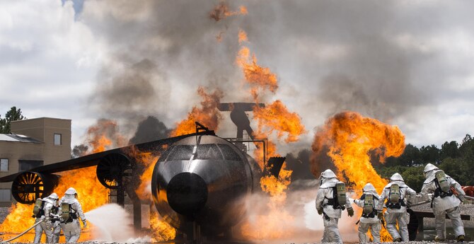 Teams of 919th Special Operations Civil Engineer Squadron firefighters battle a huge blaze during a live-fire training exercise March 4 at Hurlburt Field, Fla.  The Reserve Airmen teamed with their active-duty special operations firefighters to complete their annual live-fire training during the March unit training assembly.  (U.S. Air Force photo/Tech. Sgt. Sam King)
