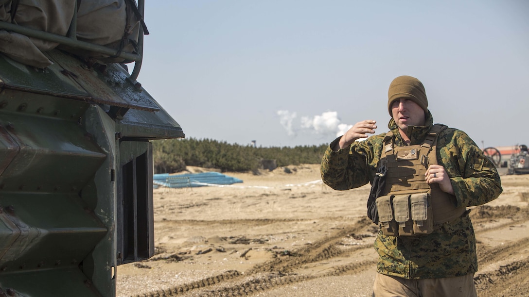 U.S. Marine Staff Sgt. Zachary Evers, with Alpha Company, Battalion Landing Team, 1st Battalion, 5th Marine Regiment, 31st Marine Expeditionary Unit, guides an AAV-P7/A1 Amphibious Assault Vehicle after conducting a combined amphibious assault on Dogu Beach, South Korea, as part of Ssang Yong 16, March 12, 2016. Ssang Yong is a biennial combined amphibious exercise conducted by U.S. forces with the Republic of Korea Navy and Marine Corps, Australian Army and Royal New Zealand Army Forces in order to strengthen interoperability and working relationships across a wide range of military operations. 