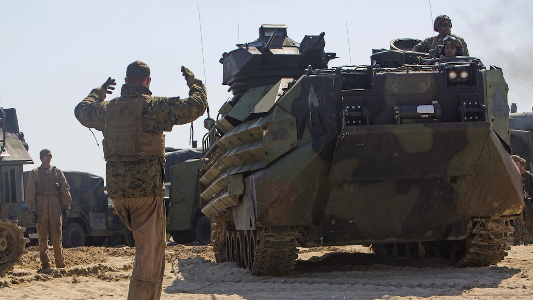 U.S. Marine Cpl. Ryan Damron, with Alpha Company, Battalion Landing Team, 1st Battalion, 5th Marine Regiment, 31st Marine Expeditionary Unit, guides an AAV-P7/A1 Amphibious Assault Vehicle after conducting a combined amphibious assault on Dogu Beach, South Korea, as part of Ssang Yong 16, March 12, 2016. Ssang Yong is a biennial combined amphibious exercise conducted by U.S. forces with the Republic of Korea Navy and Marine Corps, Australian Army and Royal New Zealand Army Forces in order to strengthen interoperability and working relationships across a wide range of military operations.