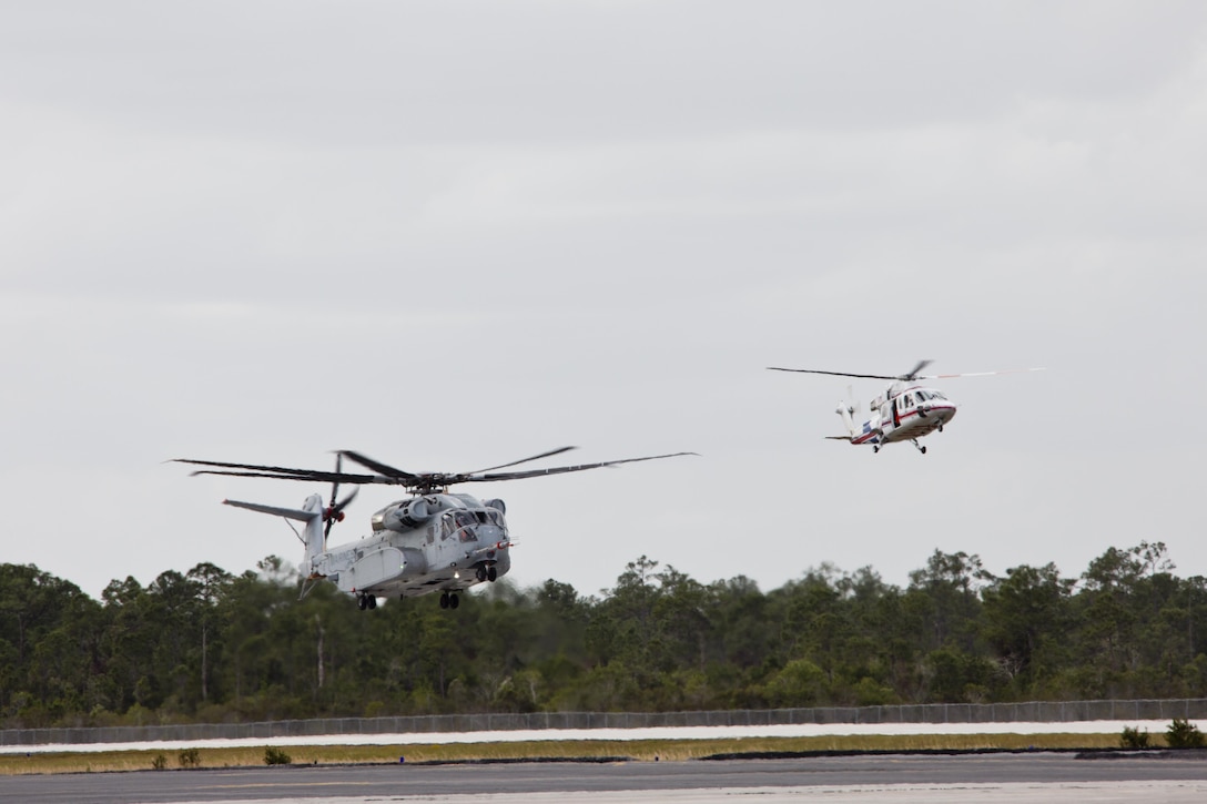 A CH-53K King Stallion aircraft, left, prepares to land at Sikorsky Aircraft Corporation, Jupiter, Fla., March 8, 2016. The CH-53K will replace the CH-53E Super Stallion aircraft, currently used by the Marine Corps. (U.S. Marine Corps photo by Staff Sgt. Gabriela Garcia/Released)