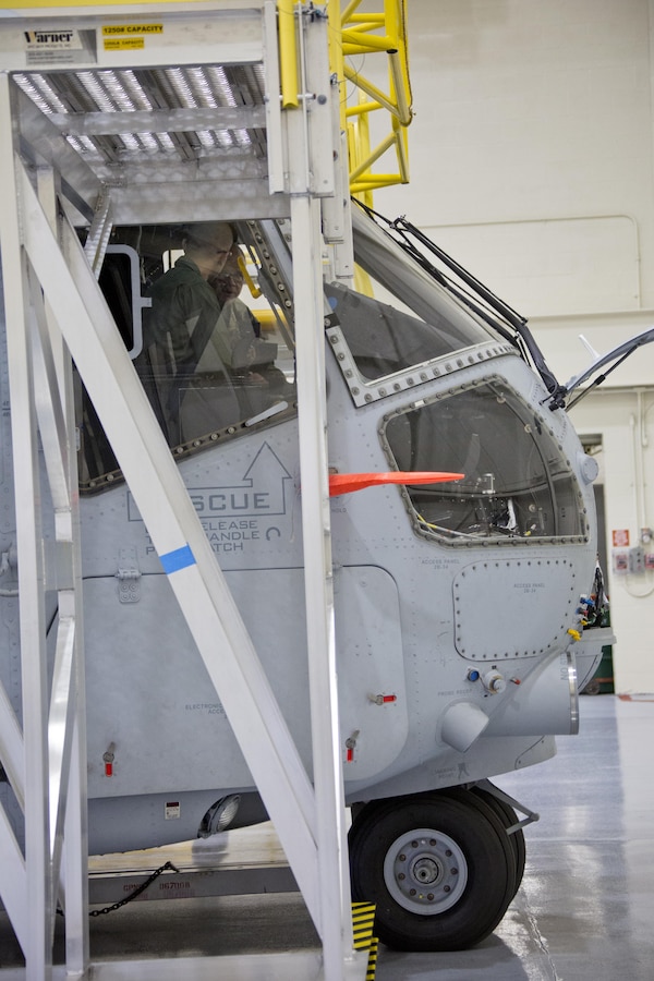 Commandant of the Marine Corps Gen. Robert B. Neller listens to an expert inside a CH-53K Super Stallion aircraft at Sikorsky Aircraft Corporation, Jupiter, Fla., March 8, 2016. Neller visited the facility to get an overview of the CH-53K program and visit Marines. (U.S. Marine Corps photo by Staff Sgt. Gabriela Garcia/Released)