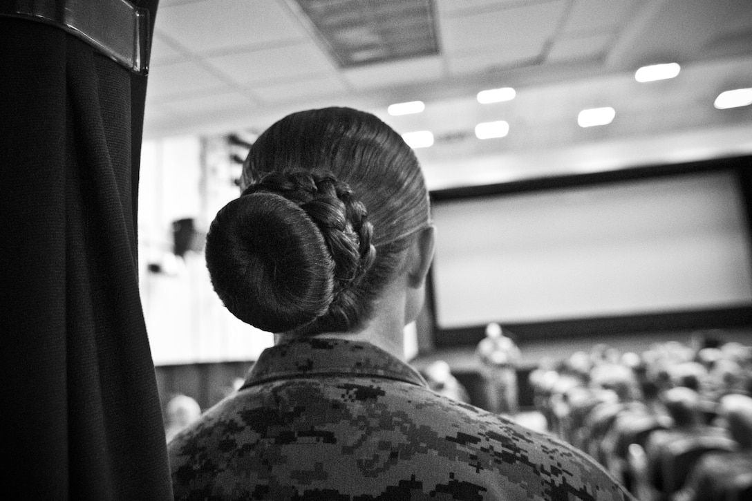 A U.S. Marine with Marine Corps Logistics Command listens to Commandant of the Marine Corps Gen. Robert B. Neller's brief at Marine Depot Maintenance Command, Albany, Ga., March 9, 2016. Neller briefed Marines, Sailors, and civilians on the current status of the Corps, his expectations, and priorities, and the imortance of protecting what each Marine has earned. (U.S. Marine Corps photo illustration by Staff Sgt. Gabriela Garcia/Released)