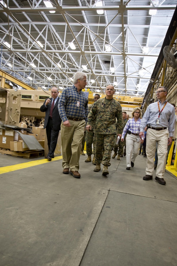 Commandant of the Marine Corps Gen. Robert B. Neller, center, listens to a brief during a tour of Marine Depot Maintenance Command at Albany, Ga., March 9, 2016. Neller toured the repair facility to assess its operational capabilities and meet the Marines and civilian employees. (U.S. Marine Corps photo by Staff Sgt. Gabriela Garcia/Released)