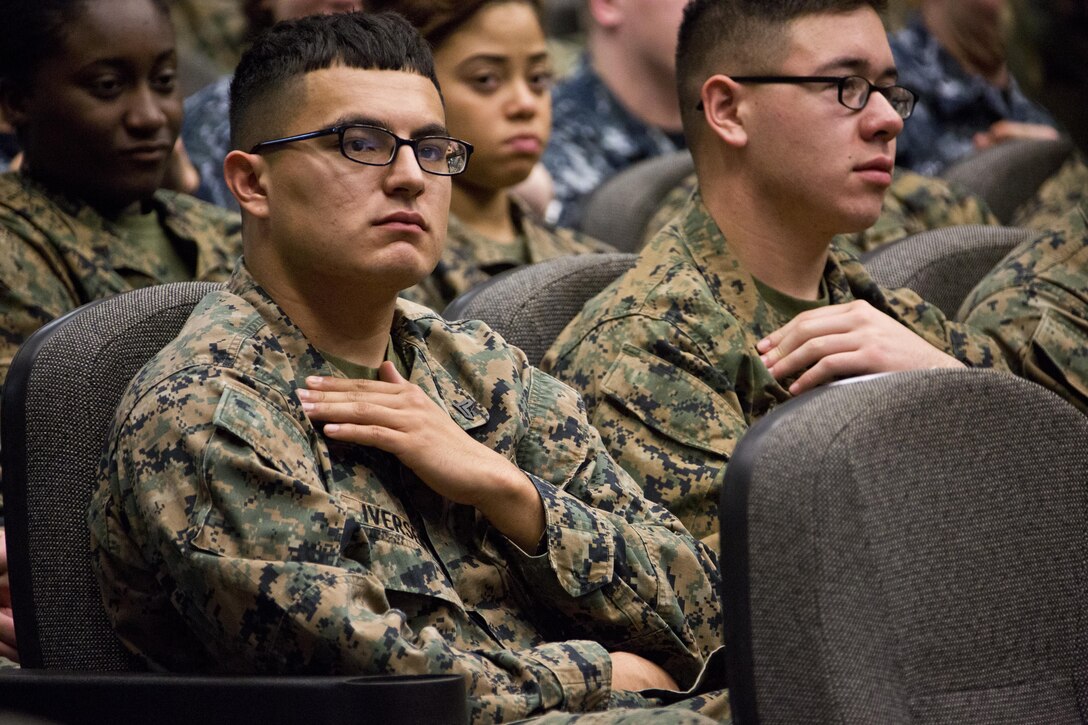 A U.S. Marine with Marine Corps Logistics Command, touches his rank insignia during Commandant of the Marine Corps Gen. Robert B. Neller's brief at Marine Depot Maintenance Command, Albany, Ga., March 9, 2016. Neller briefed Marines, Sailors, and civilians on the current status of the Corps, his expectations, and priorities, and the imortance of protecting what each Marine has earned. (U.S. Marine Corps photo by Staff Sgt. Gabriela Garcia/Released)
