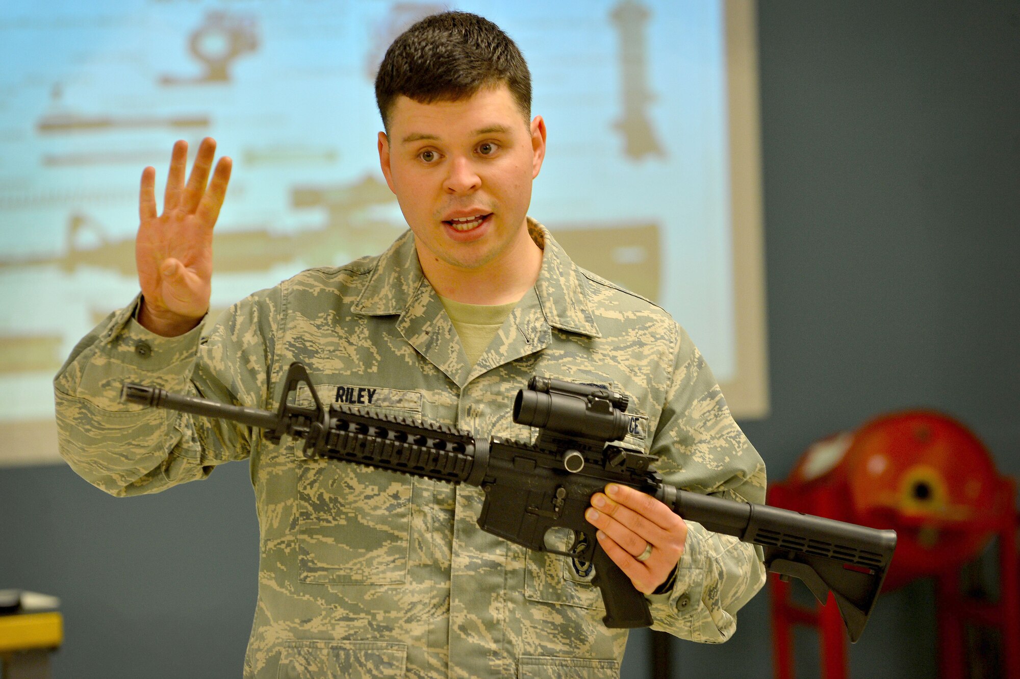 U.S. Air Force Senior Airman Robert Riley, 20th Security Forces Squadron combat arms instructor, identifies parts of the M4 carbine during combat arms training at Shaw Air Force Base, S.C., March 8, 2016. Before students are able to shoot in the range, they receive three hours of classroom instruction on weapons knowledge, safety, and shooting techniques. (U.S. Air Force photo by Senior Airman Michael Cossaboom)